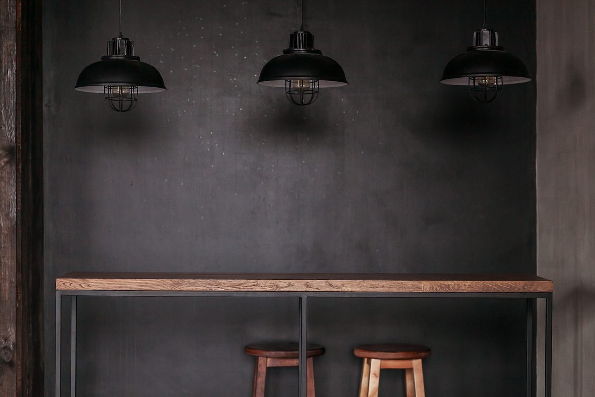 Industrial lighting. Wooden bar stools.